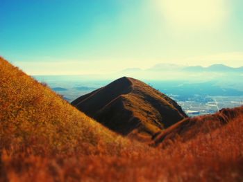 Scenic view of mountain by sea against sky