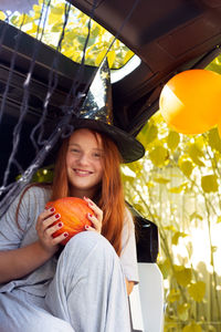 Portrait of a smiling young woman holding balloons