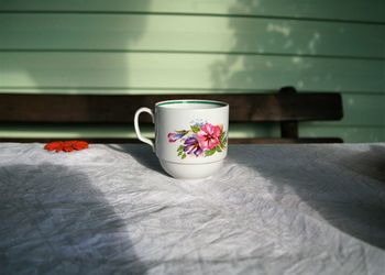 Close-up of coffee cup on table at home