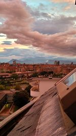 Buildings against cloudy sky at sunset