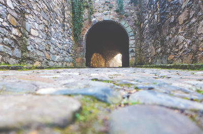 Surface level of pathway along stone walls