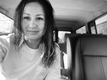 Portrait of smiling young woman in car