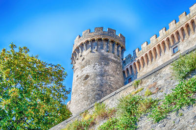 Low angle view of historic building against blue sky