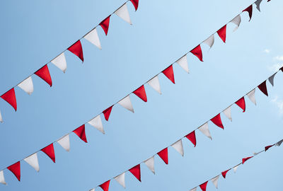 Low angle view of buntings hanging against sky