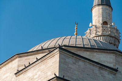 Muslim mosque architecture details with golden crescent and stone minaret. islam religion background