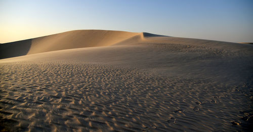 Scenic view of desert against clear sky