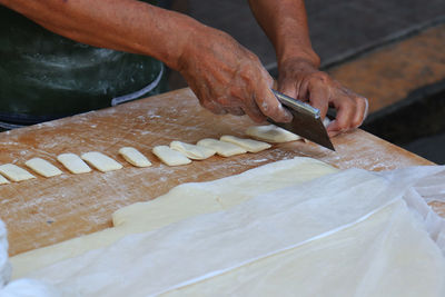 Midsection of person preparing food