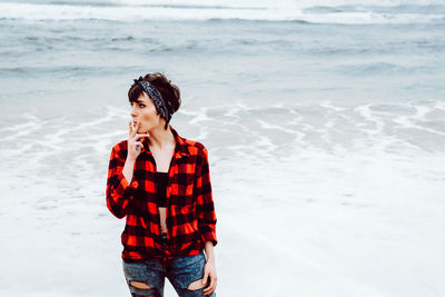 Young woman looking at sea shore