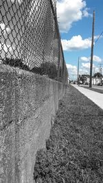 Road seen through chainlink fence