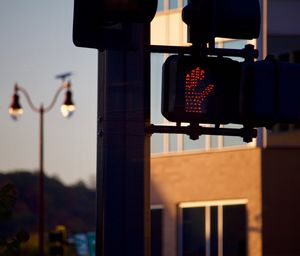 Close-up of illuminated street light against sky