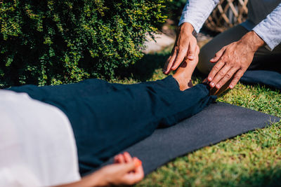 Hands of a reiki therapist healing and balancing energy points in feet. energy healing concept