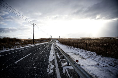 View of railroad tracks against sky during winter