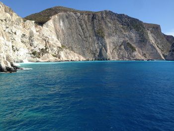 Scenic view of sea and mountains against sky