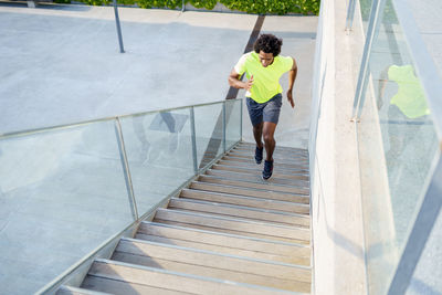 High angle view of man walking on staircase