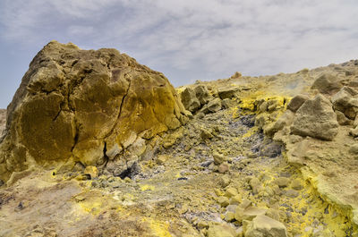 Low angle view of rock formation against sky