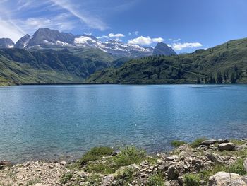 Scenic view of lake and mountains against sky