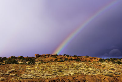 Rainbow over landscape against sky