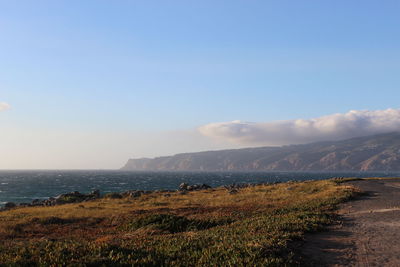 Scenic view of sea against cloudy sky