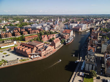 High angle view of buildings by sea against sky