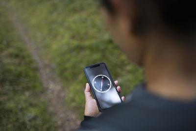 Woman using compass on smart phone