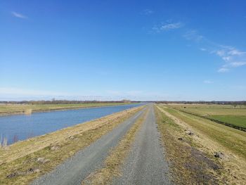 Empty road along countryside landscape