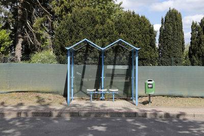 Empty playground against trees in park