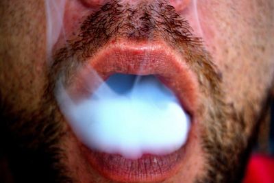 Cropped image of man smoking