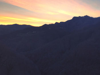 Scenic view of silhouette mountains against sky during sunset