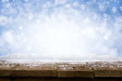 Close-up of snow on wood during winter