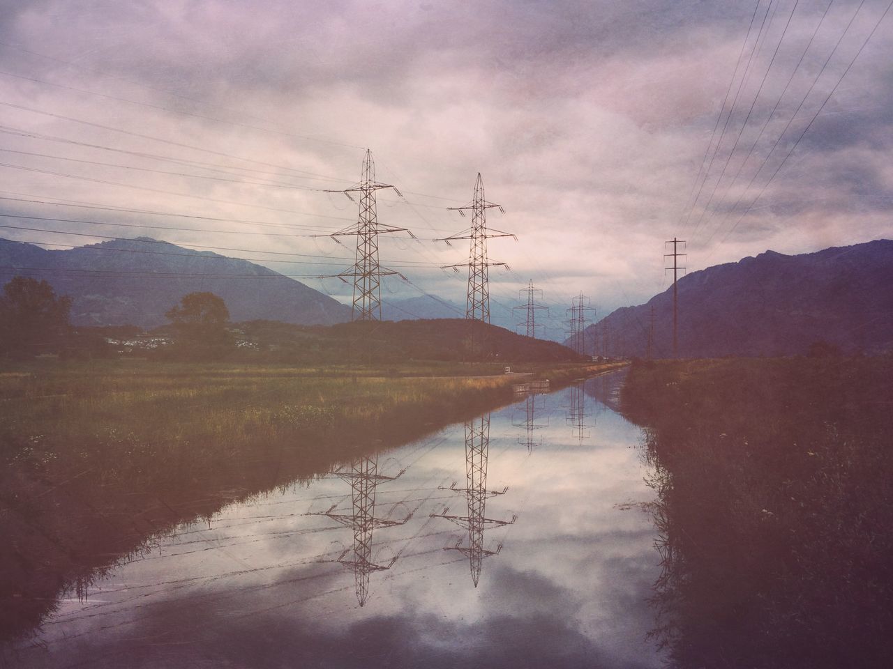 water, sky, tranquil scene, tranquility, reflection, electricity pylon, cloud - sky, scenics, power line, lake, mountain, nature, beauty in nature, landscape, cloud, cloudy, river, countryside, non-urban scene, outdoors