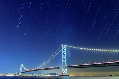 Low angle view of suspension bridge at night