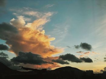 Low angle view of silhouette buildings against sky during sunset