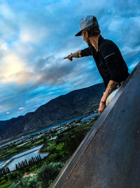 Side view of man standing on mountain