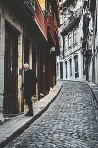 Woman walking on road in city