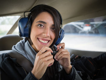 Portrait of a smiling young woman in airplane