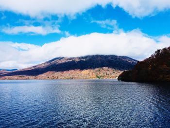 Scenic view of lake and mountains against sky