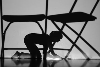 Silhouette of boy standing on floor