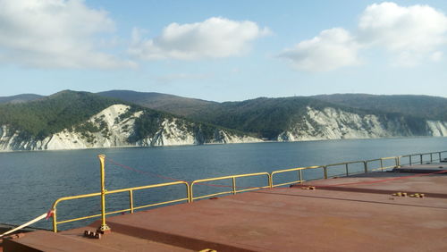 Scenic view of sea and mountains against sky