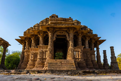 Low angle view of old temple building against clear sky