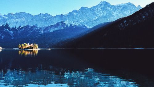 Scenic view of lake and mountains against sky