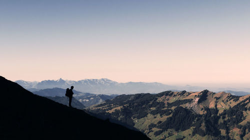 Man standing on mountain against sky