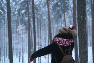 Man with cat in forest during winter