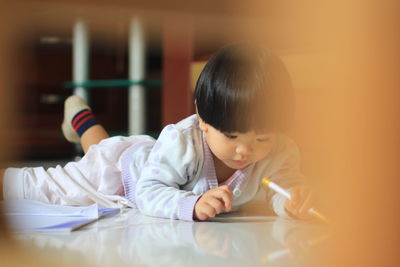 Portrait of boy sitting on table