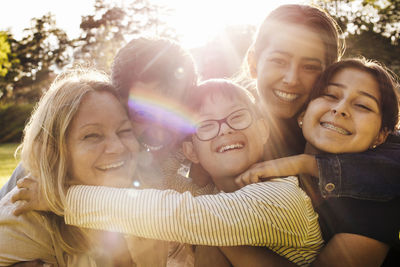 Portrait of loving family at park on sunny day