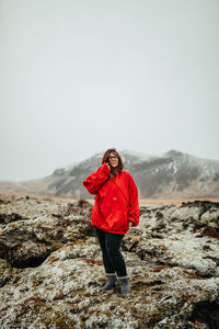 Full length of man standing on rock against sky