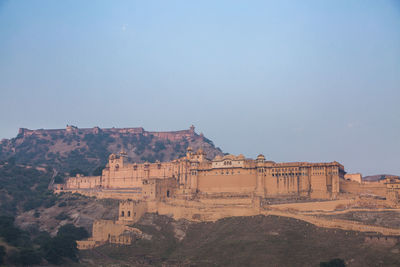 Built structure on mountain against clear sky