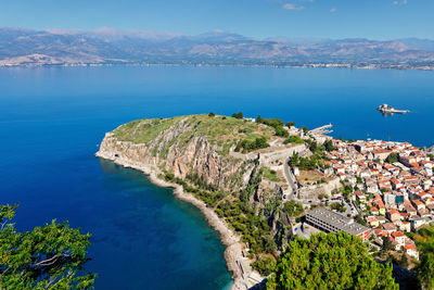 High angle view of sea and cityscape against sky