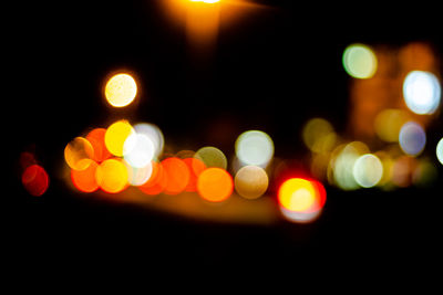 Defocused image of illuminated street lights at night