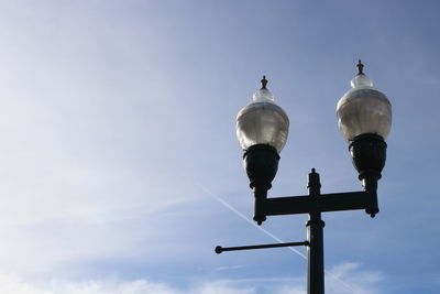 Low angle view of street light against sky