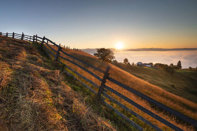 Scenic view of field against sky during sunset